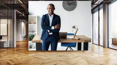 handsome cheerful african american executive business man at the workspace office. Wall mural