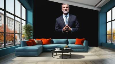 Handsome mature business man isolated on black background Wall mural