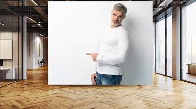 Handsome middle age senior man presenting and pointing with palm of hand looking at the camera over white background. Wall mural