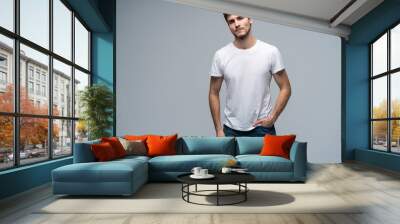 Handsome young guy posing in studio - isolated Wall mural