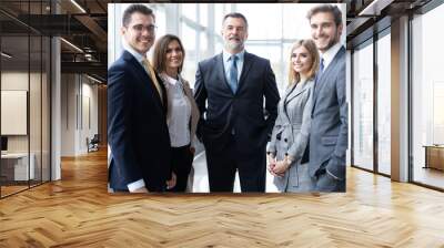 Happy business team with arms crossed at the office. Wall mural