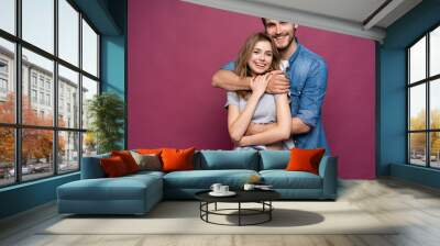 Happy loving couple isolated isolated on pink background. Wall mural