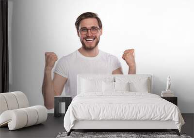 Happy winner. Happy young handsome man gesturing and keeping mouth open while standing against transparent background Wall mural