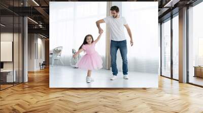 I love you, dad! Handsome young man is dancing at home with his little girl. Happy Father's Day! Wall mural