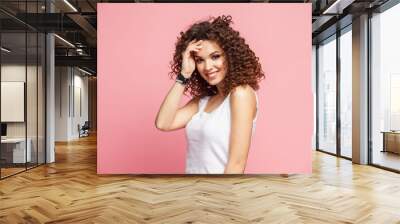 Image of happy young lady standing isolated over pink background. Looking camera pointing. Wall mural