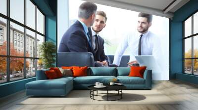 Mature businessman using digital tablet to discuss information with a younger colleague in a modern business lounge Wall mural