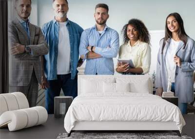 Portrait of creative business team standing together and laughing. Multiracial business people together at startup Wall mural