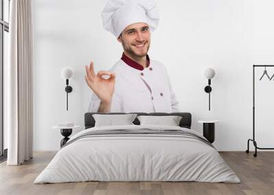 Positive professional happy man chef showing tasty ok sign isolated on white background. Wall mural