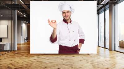 Positive professional happy man chef showing tasty ok sign isolated on white background. Wall mural