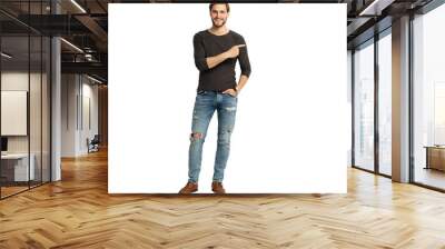 Positive young man pointing aside with fingers hand gesture at copy space advertising product, presenting sale discount standing isolated on transparent Wall mural