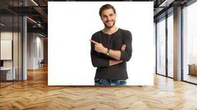 Positive young man pointing aside with fingers hand gesture at copy space advertising product, presenting sale discount standing isolated on transparent Wall mural