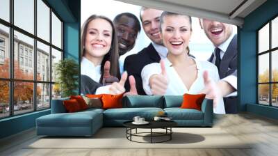 Successful young business people showing thumbs up sign Wall mural