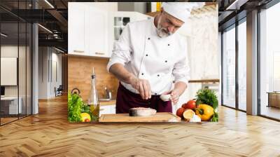 The chef prepares fresh fish salmon, trout, sprinkles with sea salt and vegetables. Horizontal photo. Concept cooking healthy and vegan cuisine, clean food, restaurants, hotel business. Wall mural