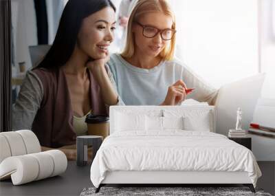 Two female colleagues in office working together. Wall mural