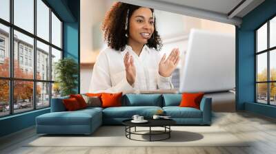 Young african american woman using laptop computer at home, distance learning, online meeting, business concept Wall mural