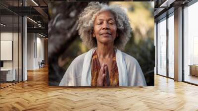 Senior woman meditating in front of a tree. Generative AI. Wall mural