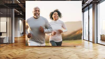 An african american couple of middle aged adults running in the morning, healthy lifestyle jogging, happy run Wall mural