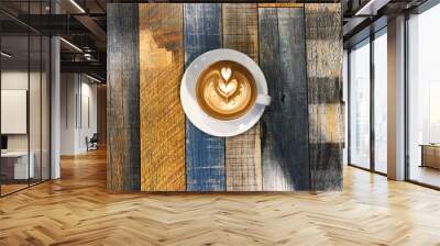 Hot Coffee Latte in colourful cup and saucer on rustic wooden table Wall mural