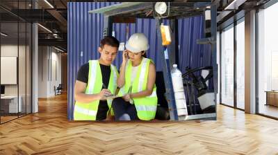 South East Asian young Malay Chinese man woman wearing white yellow safety helmet vest sting on forklift read study see talk on phone Wall mural