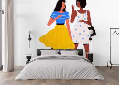 Two young women are walking together, laughing and talking. Communication, friendship and communication concept Wall mural