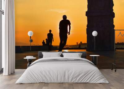 Young man skateboarder skateboarding at sunset, silhouette.  Wall mural