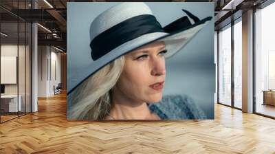 Vertical portrait of a Caucasian female wearing beach hat in Los Angeles, California, United States Wall mural