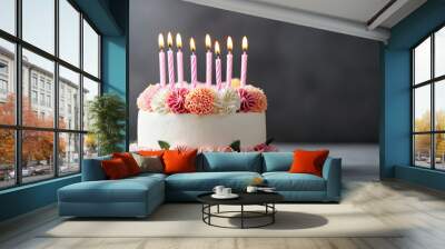 A beautifully decorated birthday cake with fresh flowers and candles, perfect for celebrating special moments and joyful occasions. Wall mural