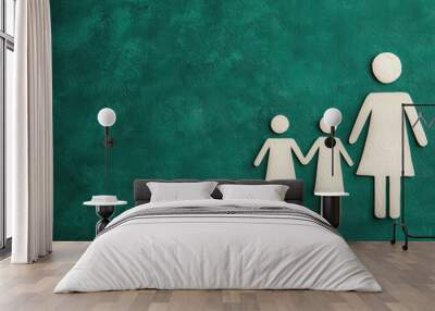 Family figures of a woman and two children on a green background. Wall mural