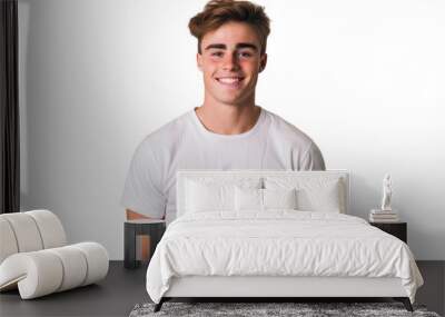 Handsome young man in a relaxed pose with a friendly smile on a white background. Wall mural