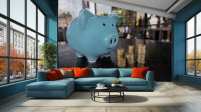 Blue piggy bank with coin pile, step up growing business to success and saving for retirement concept Wall mural