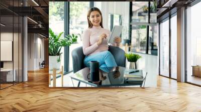 Female CEO in casual wear smiling and using tablet working Shown on the digital screen analyze and calculate the planning strategy for modern business Wall mural