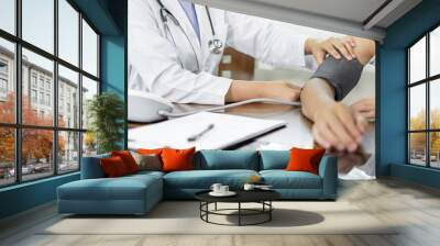 The female doctor measured blood pressure, the patient examined the heartbeat, and sat down to talk about health care closely. health care concept Wall mural