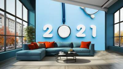 Stethoscope with 2021 number on blue background. Happy New Year for health care and medical banner/calendar cover. Creative idea for new trend in medicine treatment and diagnosis concept. Wall mural