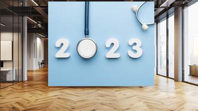 Stethoscope with 2023 number on blue background. Happy New Year for health care and medical banner calendar cover. Creative idea for new trend in medicine treatment and diagnosis concept. Wall mural