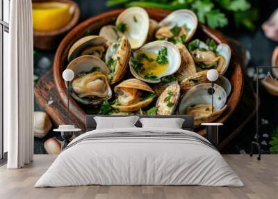 A close-up shot of a bowl of cooked clams, topped with fresh parsley and garlic. The clams are arranged in a rustic wooden bowl and served on a dark background. Wall mural