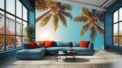 Blue sky and palm trees seen from below. Summer. Travel idea. Wall mural