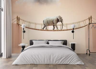 Elephant walks on rope above a gap between two cubes. Risk taking and destination concept. Wall mural