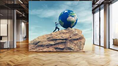 Man pushing a big earth globe Wall mural