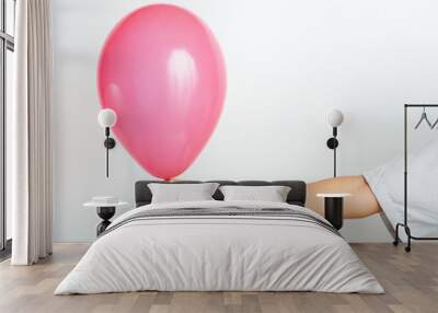 Young boy holding a red balloon with hand Wall mural