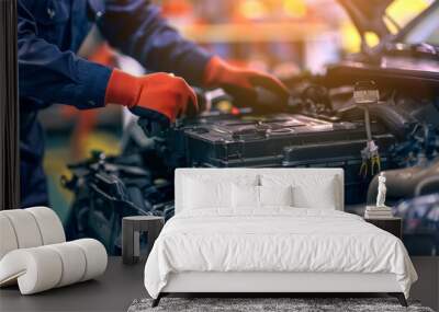 A car mechanic is shown replacing a battery during maintenance, underscoring the routine aspect of vehicle care Wall mural