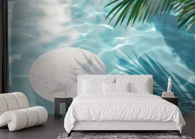 An aerial view of a marble podium stand in swimming pool water, shaded by a palm, creating a summer tropical backdrop ideal for showcasing luxury products Wall mural