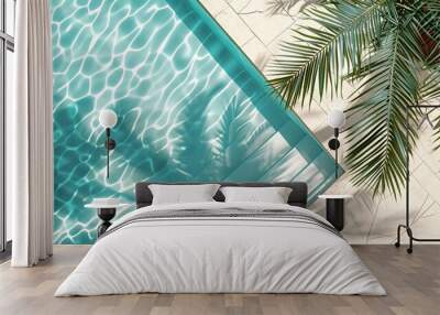 An overhead view of a luxurious swimming pool with the shadow of a palm cast on the water, creating a tropical background ideal for product placement on a podium mockup Wall mural