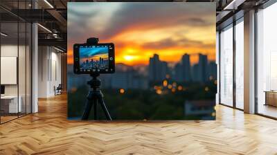 Smartphone attached to a tripod, capturing a vibrant city panorama Wall mural