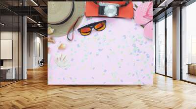 Table top view aerial image of woman clothing for travel beach or sea in summer holiday season background concept.Flat lay essential objects on modern pink paper with confetti and copy space. Wall mural