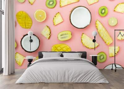 Table top view fruit tropical with spring summer holiday & vacation  background concept.Arrangement sliced various pineapple kiwi mango lemon and lime coconut on  pink paper.flat lay & pastel tone. Wall mural