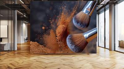 Two cosmetics brushes collide at high speed, dispersing make up powdrer isolated on dark backdrop. Wall mural