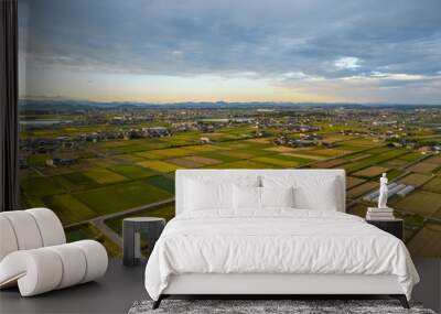 Late afternoon sun hits rice fields in autumn harvest season Wall mural