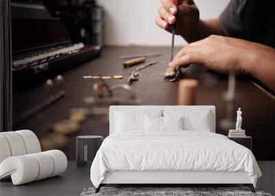 instrument repairman removing old pads from flute keys Wall mural