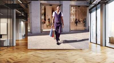 man leaving store with shopping bags Wall mural