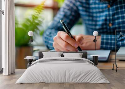 hand view businessman writing on a clipboard sitting at a desk in the office Wall mural